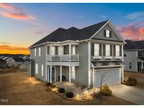 Two-story house with gray siding, balcony, and attached garage at 655 Hawksbill Dr, Franklinton, NC 27525