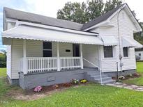 Charming white house with a porch, steps, and well-maintained lawn at 723 S Washington St, Rocky Mount, NC 27801