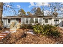 Charming ranch home with gray siding, red door, and mature landscaping at 100 Forestwood Dr, Durham, NC 27707