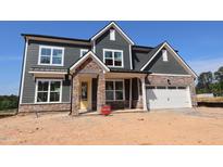 New two-story home with stone and siding details and a two-car garage at 1104 Opal Ln # 104, Durham, NC 27705