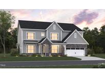 Two-story home with gray siding, stone accents, and a three-car garage at 1104 Opal Ln # 104, Durham, NC 27705