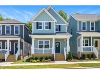 Two-story craftsman style home with light teal siding, white trim, and a front porch at 121 Weavers Grv Dr, Chapel Hill, NC 27514