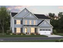 Two-story house with gray siding, a white garage door, and landscaping at 1112 Opal Ln # 102, Durham, NC 27705