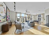 Spacious living room with hardwood floors, large windows, and ample natural light at 200 S Dawson St # 406, Raleigh, NC 27601