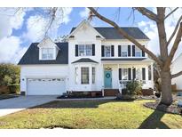 Two-story white house with black shutters, attached garage, and manicured lawn at 60 Green Meadow Ct, Pittsboro, NC 27312