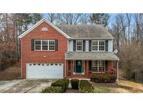 Two-story brick home with a large front yard and attached garage at 6645 Austin Creek Dr, Wake Forest, NC 27587