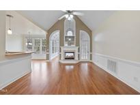 Bright living room features a fireplace, hardwood floors, and ample natural light at 701 Occoneechee Dr, Fuquay Varina, NC 27526
