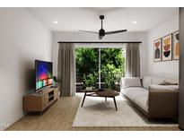 Bright living room featuring modern furniture and access to a balcony at 711 E Lenoir St # 205, Raleigh, NC 27601