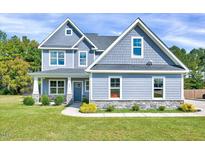 Charming two-story home with gray siding, shingle accents, landscaped yard, and covered front porch at 798 Christian Light Rd, Fuquay Varina, NC 27526