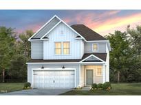 Two-story home with gray siding, white accents, and a two-car garage at 1011 Freestone Rd, Durham, NC 27703