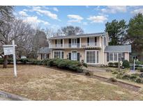 Two-story house with wrap-around porch and landscaped yard at 110 E Orange St, Hillsborough, NC 27278