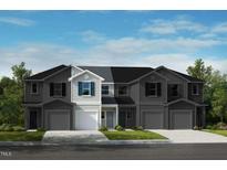 Two-story townhome with gray and white siding, attached garage, and small front yard at 1109 Mountain Crown St, Durham, NC 27703