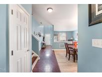 Inviting foyer with hardwood floors leads to the dining room at 112 Smith Rock Dr, Holly Springs, NC 27540