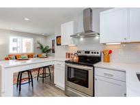 Modern kitchen with stainless steel appliances and white cabinetry at 1309 Hudson Ave # D11, Durham, NC 27705