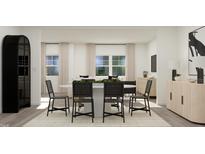 Modern dining room features a round table with black chairs and a stylish light wood cabinet at 1331 Hazelnut Ridge Ln # 177, Knightdale, NC 27545