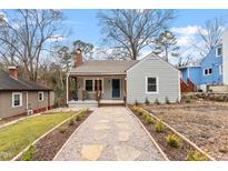 Charming single-story home with gray siding, inviting front porch, and landscaped front yard at 1606 James St, Durham, NC 27707