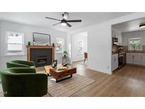 Bright living room with fireplace, hardwood floors, and modern furniture at 1606 James St, Durham, NC 27707