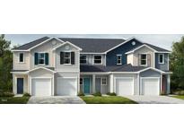 Three-unit townhome building with modern exterior finishes and two-car garages at 1997 Rabbitbrush St, Durham, NC 27703