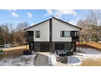 Modern two-unit building with dark gray accents and attached garages at 2201 Millbank Village Ct # 101, Raleigh, NC 27610