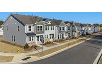 Row of townhouses with gray siding and attached garages at 316 Church St # 38, Wendell, NC 27591