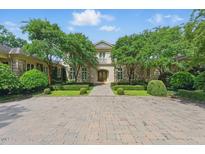 Stunning stone home with meticulously manicured landscaping and a circular driveway at 32602 Archdale, Chapel Hill, NC 27517