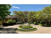 Stately two-story home with manicured landscaping and circular driveway at 32602 Archdale, Chapel Hill, NC 27517