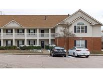 Two-story condo building with brick and siding exterior, and parking at 4024 Claret Ln, Morrisville, NC 27560