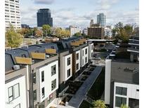 Aerial view of modern townhouses, showcasing city skyline views and community layout at 512 Gordon Street # 303, Durham, NC 27701