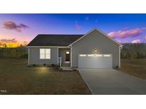 Gray siding house with a 2-car garage and landscaped yard at 75 Brookhaven Dr, Spring Hope, NC 27882