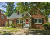 Charming brick home with stone accents, black shutters, and a well-maintained front yard at 945 Sycamore St, Rocky Mount, NC 27801