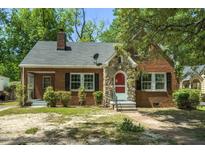 Brick house with stone accents, red door, and landscaped yard at 945 Sycamore St, Rocky Mount, NC 27801