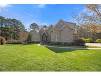 Beautiful brick home with a manicured lawn and meticulously kept landscaping at 101 Bonica Creek Dr, Garner, NC 27529