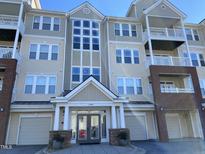 Beige 3-story building with multiple balconies and a main entrance at 1401 Coopershill Dr # 211, Raleigh, NC 27604