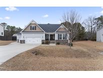 Two-story house with gray siding, stone accents, and a two-car garage at 217 Willirene Way, Clayton, NC 27520