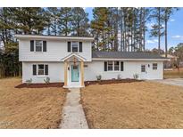 Charming two-story home with a light-blue door, white painted brick, and black shutters at 3305 Victor Pl, Raleigh, NC 27604