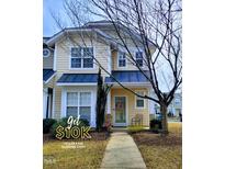 Inviting two-story home with a charming front door and well-maintained landscaping at 4202 Cherry Blossom Cir, Durham, NC 27713
