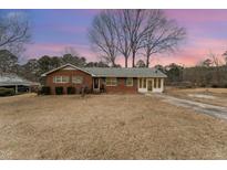 Brick ranch house with a spacious yard at 516 Maple Ln, Raleigh, NC 27603