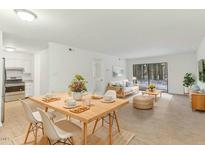 Bright and airy living and dining area with wood floors, modern furnishings, and sliding glass door to the outside at 642 Pine Ridge Pl, Raleigh, NC 27609