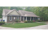 Two-story house with stone accents and a covered porch at 7115 Laurel Point Dr, Gibsonville, NC 27249