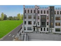 Modern townhome exterior showcasing a clean design and private rooftop terrace at 101 Ailey Brook Way # 100, Wake Forest, NC 27587