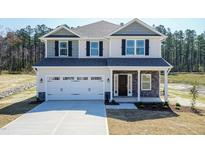 Two-story house with gray siding, white trim, and a stone facade at 128 High Hampton Way, Fuquay Varina, NC 27526