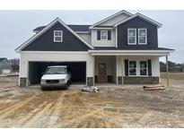 New construction home with two-car garage, stone accents, and craftsman-style details at 141 Trescott St, Smithfield, NC 27577