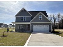Charming two-story home with gray siding, stone accents, and a two-car garage at 15 Lupin Dr, Smithfield, NC 27577