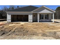 New construction home featuring attached garage and covered entryway, set on a spacious lot at 282 Trescott St, Smithfield, NC 27577