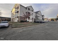 Beige multi-unit building with ample parking at 3015 Winston Dr # Apt 102, Burlington, NC 27215