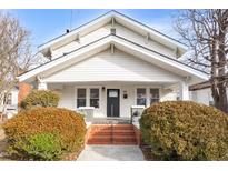 Charming white house with brick steps and well-manicured landscaping at 507 Price Ave, Durham, NC 27701