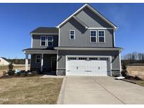Charming two-story home featuring gray siding, white trim, and a spacious two car garage at 53 Barony Ln, Smithfield, NC 27577