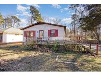 Ranch home with red shutters, deck, and large yard at 602 E Club Blvd, Durham, NC 27704