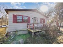 Exterior shot showing a single story home with a deck, red shutters, and gray paint at 602 E Club Blvd, Durham, NC 27704