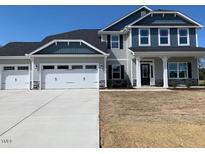 Two story home with three car garage and gray siding at 62 Faircox Way # 139, Garner, NC 27529